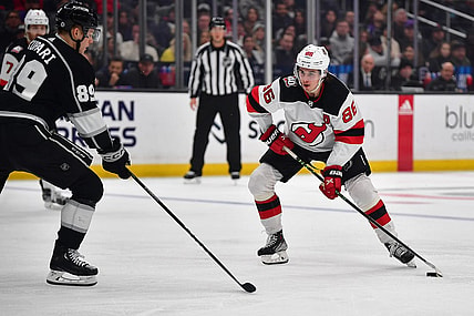 January 14, 2023; Los Angeles, California, USA; New Jersey Devils center Jack Hughes (86) moves the puck against Los Angeles Kings center Rasmus Kupari (89) during the third period at Crypto.com Arena. Mandatory Credit: Gary A. Vasquez-USA TODAY Sports