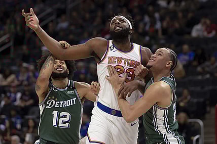 Jan 15, 2023; Detroit, Michigan, USA; New York Knicks center Mitchell Robinson (23) battles for position between Detroit Pistons forward Isaiah Livers (12) forward Kevin Knox II (20) during the first quarter at Little Caesars Arena. Mandatory Credit: David Reginek-USA TODAY Sports