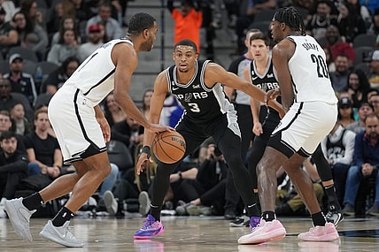 Jan 17, 2023; San Antonio, Texas, USA;  San Antonio Spurs forward Keldon Johnson (3) defends Brooklyn Nets forward T.J. Warren (1) in the first half at the AT&T Center. Mandatory Credit: Daniel Dunn-USA TODAY Sports