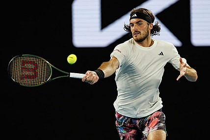 Jan 24, 2023; Melbourne, Victoria, Australia;  Stefanos Tsitsipas of Greece hits a shot against Jiri Lehecka of the Czech Republic on day nine of the 2023 Australian Open tennis tournament at Melbourne Park. Mandatory Credit: Mike Frey-USA TODAY Sports