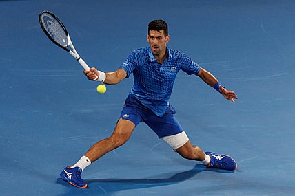 Jan 27, 2023; Melbourne, Victoria, Australia;  Novak Djokovic of Serbia hits a shot against Tommy Paul of the United States on day twelve of the 2023 Australian Open tennis tournament at Melbourne Park. Mandatory Credit: Mike Frey-USA TODAY Sports