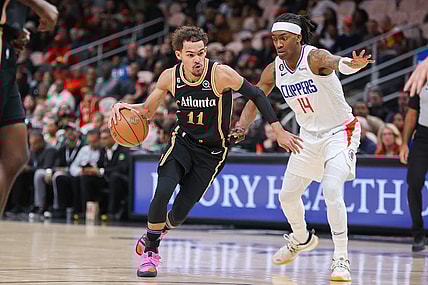 Jan 28, 2023; Atlanta, Georgia, USA; Atlanta Hawks guard Trae Young (11) drives on LA Clippers guard Terance Mann (14) in the first quarter at State Farm Arena. Mandatory Credit: Brett Davis-USA TODAY Sports