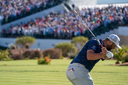 Feb 11, 2022; Scottsdale, Arizona, USA; Jon Rahm plays his tee shot on the par 3 16th hole during the second round of the WM Phoenix Open golf tournament. Mandatory Credit: Allan Henry-USA TODAY Sports
