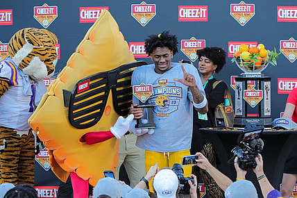 Jan 2, 2023; Orlando, FL, USA; LSU Tigers wide receiver Malik Nabers (8) is presented with most valuable player trophy by Cheez-it mascot after the game against the Purdue Boilermakers at Camping World Stadium. Mandatory Credit: Mike Watters-USA TODAY Sports