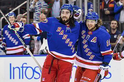 Jan 3, 2023; New York, New York, USA; New York Rangers left wing Artemi Panarin (10) celebrates the goal by New York Rangers center Mika Zibanejad (93) against the Carolina Hurricanes during the second period at Madison Square Garden. Mandatory Credit: Dennis Schneidler-USA TODAY Sports