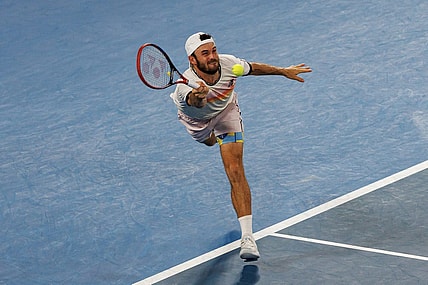 Jan 27, 2023; Melbourne, Victoria, Australia; Tommy Paul of the United States hits a shot against Novak Djokovic of Serbia on day twelve of the 2023 Australian Open tennis tournament at Melbourne Park. Mandatory Credit: Mike Frey-USA TODAY Sports
