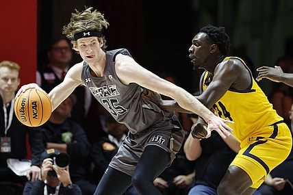 Feb 5, 2023; Salt Lake City, Utah, USA; Utah Utes center Branden Carlson (35) looks to drive against California Golden Bears forward Sam Alajiki (24) in the first half at Jon M. Huntsman Center. Mandatory Credit: Jeffrey Swinger-USA TODAY Sports