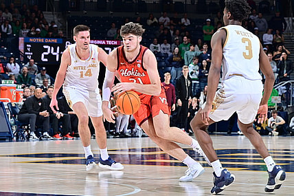 Feb 11, 2023; South Bend, Indiana, USA; Virginia Tech Hokies forward Grant Basile (21) dribbles between Notre Dame Fighting Irish forward Nate Laszewski (14) and guard Trey Wertz (3) in the first half at the Purcell Pavilion. Mandatory Credit: Matt Cashore-USA TODAY Sports