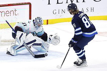 Feb 14, 2023; Winnipeg, Manitoba, CAN; Seattle Kraken goaltender Philipp Grubauer (31) stops a shot by Winnipeg Jets left wing Kyle Connor (81) in the shoot out at Canada Life Centre. Mandatory Credit: James Carey Lauder-USA TODAY Sports