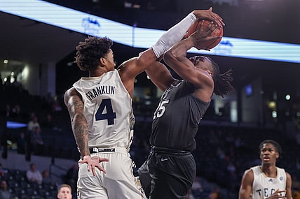 Feb 15, 2023; Atlanta, Georgia, USA; Georgia Tech Yellow Jackets forward Javon Franklin (4) blocks the shot of Virginia Tech Hokies forward Justyn Mutts (25) in the first half at McCamish Pavilion. Mandatory Credit: Brett Davis-USA TODAY Sports
