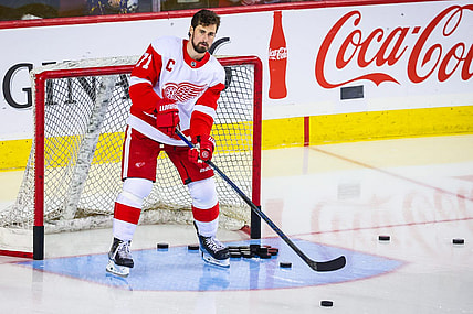 Feb 16, 2023; Calgary, Alberta, CAN; Detroit Red Wings center Dylan Larkin (71) passes the pucks during the warmup period against the Calgary Flames at Scotiabank Saddledome. Mandatory Credit: Sergei Belski-USA TODAY Sports