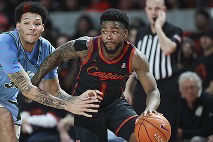 Feb 22, 2023; Houston, Texas, USA; Houston Cougars guard Jamal Shead (1) controls the ball as Tulane Green Wave forward Tylan Pope (33) defends during the second half at Fertitta Center. Mandatory Credit: Troy Taormina-USA TODAY Sports