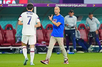 Dec 3, 2022; Al Rayyan, Qatar; United States of America manager Gregg Berhalter talks with midfielder Giovanni Reyna (7) against the Netherlands during the second half of a round of sixteen match in the 2022 FIFA World Cup at Khalifa International Stadium. Mandatory Credit: Danielle Parhizkaran-USA TODAY Sports