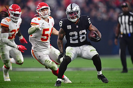 Jan 7, 2023; Paradise, Nevada, USA; Las Vegas Raiders running back Josh Jacobs (28) runs the ball against the Kansas City Chiefs during the second half at Allegiant Stadium. Mandatory Credit: Gary A. Vasquez-USA TODAY Sports