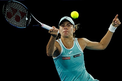 Jan 26, 2023; Melbourne, Victoria, Australia; Magda Linette of Poland hits a shot against Aryna Sabalenka of Russia on day eleven of the 2023 Australian Open tennis tournament at Melbourne Park. Mandatory Credit: Mike Frey-USA TODAY Sports