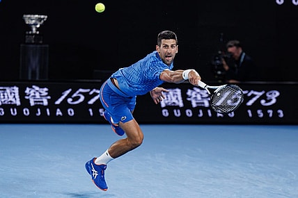 Jan 29, 2023; Melbourne, Victoria, Australia; Novak Djokovic of Serbia hits a shot against Stefanos Tsitsipas of Greece at the men's final on day fourteen of the 2023 Australian Open tennis tournament at Melbourne Park. Mandatory Credit: Mike Frey-USA TODAY Sports