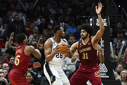 Feb 13, 2023; Cleveland, Ohio, USA; Cleveland Cavaliers center Jarrett Allen (31) and guard Donovan Mitchell (45) defend against San Antonio Spurs center Charles Bassey (28) during the second half at Rocket Mortgage FieldHouse. Mandatory Credit: Ken Blaze-USA TODAY Sports