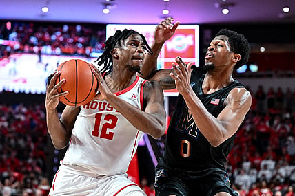 Feb 19, 2023; Houston, Texas, USA; Houston Cougars guard Tramon Mark (12) against Memphis Tigers guard Elijah McCadden (0) during the second half at Fertitta Center. Mandatory Credit: Maria Lysaker-USA TODAY Sports