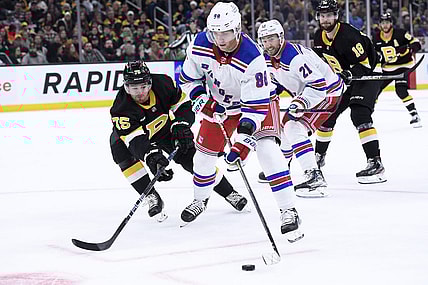 Mar 4, 2023; Boston, Massachusetts, USA; New York Rangers right wing Patrick Kane (88) controls the puck ahead of Boston Bruins defenseman Connor Clifton (75) during the second period at TD Garden. Mandatory Credit: Bob DeChiara-USA TODAY Sports
