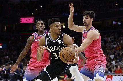 Mar 5, 2023; Washington, District of Columbia, USA; Milwaukee Bucks forward Giannis Antetokounmpo (34) holds the ball as Washington Wizards forward Deni Avdija (9) and Wizards guard Delon Wright (55) defend at Capital One Arena. Mandatory Credit: Geoff Burke-USA TODAY Sports