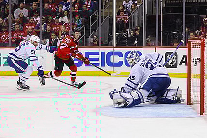 Mar 7, 2023; Newark, New Jersey, USA; Toronto Maple Leafs goaltender Ilya Samsonov (35) makes a save on New Jersey Devils center Jack Hughes (86) during the second period at Prudential Center. Mandatory Credit: Ed Mulholland-USA TODAY Sports