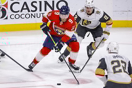 Mar 7, 2023; Sunrise, Florida, USA; Florida Panthers center Sam Bennett (9) moves the puck ahead of Vegas Golden Knights defenseman Zach Whitecloud (2) during the second period at FLA Live Arena. Mandatory Credit: Sam Navarro-USA TODAY Sports