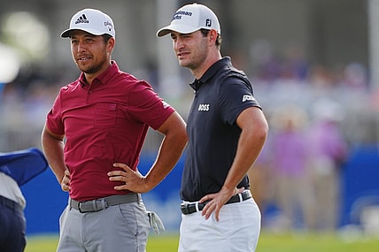 Apr 23, 2022; Avondale, Louisiana, USA; Xander Schauffele and Patrick Cantlay react after playing hole 18 during the third round of the Zurich Classic of New Orleans golf tournament. Mandatory Credit: Andrew Wevers-USA TODAY Sports