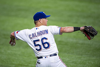 Jul 16, 2022; Arlington, Texas, USA; Texas Rangers left fielder Kole Calhoun (56) throws the ball into the infield during the sixth inning against the Seattle Mariners at Globe Life Field. Mandatory Credit: Jerome Miron-USA TODAY Sports
