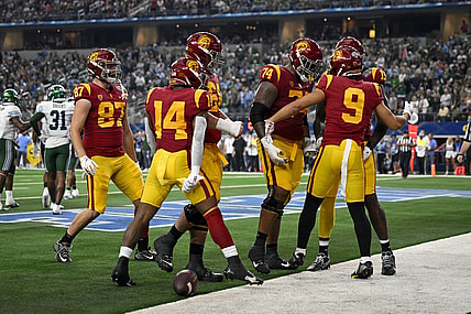 Jan 2, 2023; Arlington, Texas, USA; USC Trojans wide receiver Michael Jackson III (9) and offensive lineman Courtland Ford (74) and running back Raleek Brown (14) and tight end Lake McRee (87) celebrate after Jackson scores a touchdown against the Tulane Green Wave during the first half in the 2023 Cotton Bowl at AT&T Stadium. Mandatory Credit: Jerome Miron-USA TODAY Sports