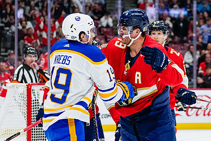 Feb 24, 2023; Sunrise, Florida, USA; Buffalo Sabres center Peyton Krebs (19) and Florida Panthers left wing Matthew Tkachuk (19) fight during the first period at FLA Live Arena. Mandatory Credit: Rich Storry-USA TODAY Sports