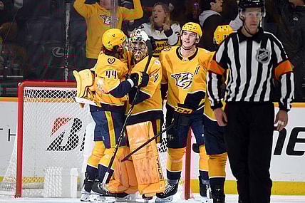 Apr 6, 2023; Nashville, Tennessee, USA; Nashville Predators goaltender Juuse Saros (74) is congratulated by left wing Kiefer Sherwood (44) and defenseman Cal Foote (52) after a shutout win against the Carolina Hurricanes at Bridgestone Arena. Mandatory Credit: Christopher Hanewinckel-USA TODAY Sports
