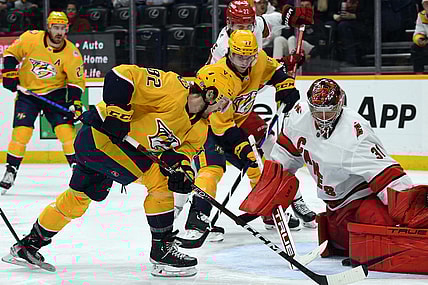 Apr 6, 2023; Nashville, Tennessee, USA; Nashville Predators center Tommy Novak (82) gets the puck past Carolina Hurricanes goaltender Frederik Andersen (31) before it is stopped on the goal line during the third period at Bridgestone Arena. Mandatory Credit: Christopher Hanewinckel-USA TODAY Sports
