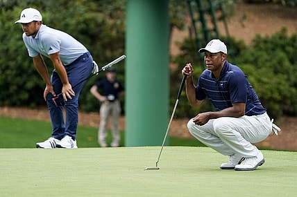 Apr 7, 2023; Augusta, Georgia, USA; Xander Schauffele and Tiger Woods line up putts on the tenth green during the second round of The Masters golf tournament. Mandatory Credit: Danielle Parhizkaran-USA TODAY Network