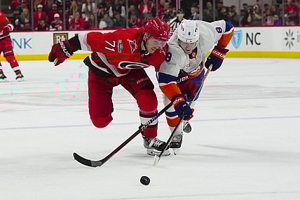 Apr 19, 2023; Raleigh, North Carolina, USA; Carolina Hurricanes right wing Jesper Fast (71) and New York Islanders defenseman Noah Dobson (8) chase after the puck during the third period in game two of the first round of the 2023 Stanley Cup Playoffs at PNC Arena. Mandatory Credit: James Guillory-USA TODAY Sports