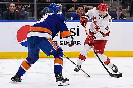 Apr 21, 2023; Elmont, New York, USA; Carolina Hurricanes center Sebastian Aho (20) attempts a shot defended by New York Islanders defenseman Noah Dobson (8) during the first period in game three of the first round of the 2023 Stanley Cup Playoffs at UBS Arena. Mandatory Credit: Dennis Schneidler-USA TODAY Sports