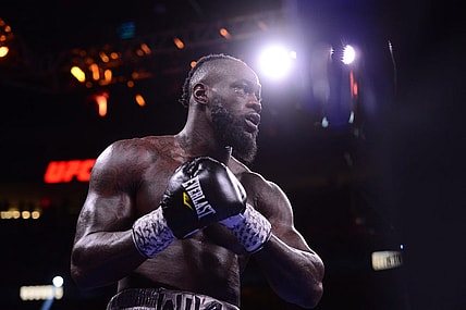 Oct 9, 2021; Las Vegas, Nevada, USA; Deontay Wilder (red/black trunks) and Tyson Fury (black/gold trunks) box during their WBC/Lineal heavyweight championship boxing match at T-Mobile Arena. Mandatory Credit: Joe Camporeale-USA TODAY Sports