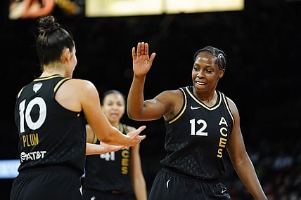 Sep 13, 2022; Las Vegas, Nevada, USA; Las Vegas Aces guard Chelsea Gray (12) celebrates with guard Kelsey Plum (10) during the fourth quarter in game two of the 2022 WNBA Finals against the Connecticut Sun at Michelob Ultra Arena. Mandatory Credit: Lucas Peltier-USA TODAY Sports
