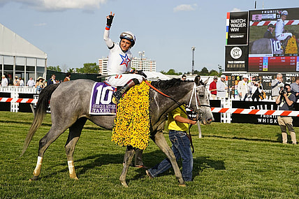 May 19, 2023; Baltimore, Maryland, USA; Taxed with Rafael Bejarno up (10) waves to the crowd after winning the Black Eyed Susan at Pimlico Race Course. Mandatory Credit: Gregory Fisher-USA TODAY Sports