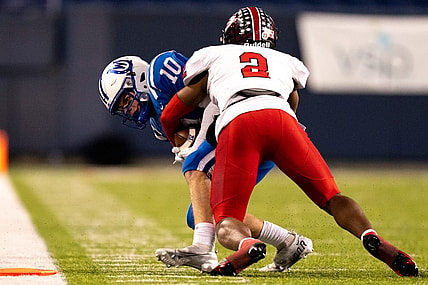 Cleveland Glenville defensive back Bryce West (2) tackles Wyoming Cowboys wide receiver Will Svendsen (10) causing a turnover on downs in the third quarter of the OHSAA DIV state championship game between at Tom Benson Hall of Fame Stadium in Canton, Ohio, on Saturday, Dec. 3, 2022.

High School Football Wyoming Vs Cleveland Glenville In Ohsaa Div State Championship Game