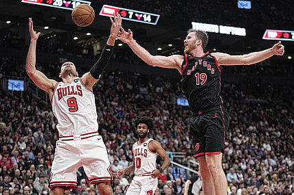 Apr 12, 2023; Toronto, Ontario, CAN; Chicago Bulls center Nikola Vucevic (9) and Toronto Raptors center Jakob Poeltl (19) battle for a rebound during the second half of a NBA Play-In game at Scotiabank Arena. Mandatory Credit: John E. Sokolowski-USA TODAY Sports