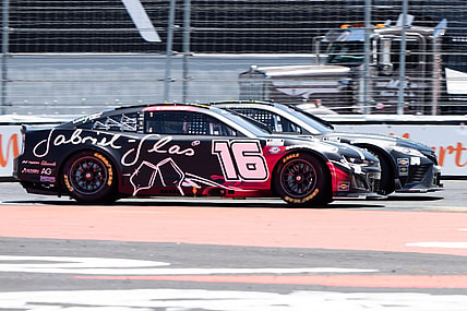 Jun 11, 2023; Sonoma, California, USA;  NASCAR Cup Series driver AJ Allmendinger (16) races against NASCAR Cup Series driver Ty Gibbs (54) at Sonoma Raceway. Mandatory Credit: Stan Szeto-USA TODAY Sports