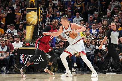 Jun 12, 2023; Denver, Colorado, USA; Denver Nuggets center Nikola Jokic (15) dribbles the ball against Miami Heat center Bam Adebayo (13) during the third quarter in game five of the 2023 NBA Finals at Ball Arena. Mandatory Credit: Kyle Terada-USA TODAY Sports