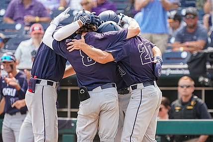 Jun 16, 2023; Omaha, NE, USA; Oral Roberts Golden Eagles second baseman Blaze Brothers (8), outfielder Sam Thompson (20), first baseman Jake McMurray (4) and third baseman Holden Breeze (5) celebrate after a three-run home run by Brothers during the ninth inning at Charles Schwab Field Omaha. Mandatory Credit: Dylan Widger-USA TODAY Sports