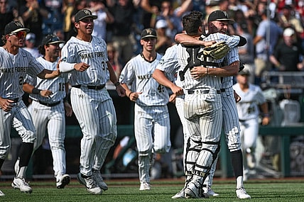 Jun 17, 2023; Omaha, NE, USA; Wake Forest Demon Deacons pitcher Camden Minacci (14) and catcher Bennett Lee (27) celebrate after defeating the Stanford Cardinal at Charles Schwab Field Omaha. Mandatory Credit: Steven Branscombe-USA TODAY Sports