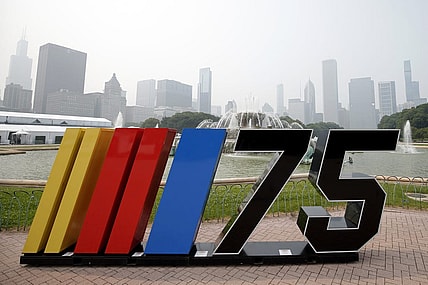 Jun 27, 2023; Chicago, Illinois, USA; A general view of a NASCAR sign next to Buckingham Fountain before the Chicago Street Race as smoke from Canadian wildfires obscures the skyline. Mandatory Credit: Jon Durr-USA TODAY Sports
