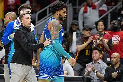Apr 13, 2022; Atlanta, Georgia, USA; Charlotte Hornets forward Miles Bridges (0) is restrained after being called for a technical foul and being ejected from the game against the Atlanta Hawks during the second half at State Farm Arena. Mandatory Credit: Dale Zanine-USA TODAY Sports