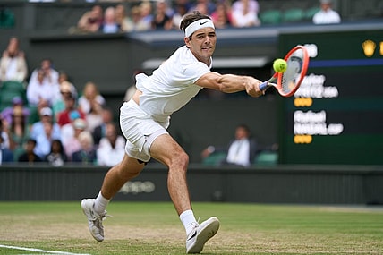 Jul 6, 2022; London, England, United Kingdom; Taylor Fritz (USA) returns a shot during his quarter finals men   s singles match against Rafael Nadal (ESP) on Centre court at All England Lawn Tennis and Croquet Club. Mandatory Credit: Peter van den Berg-USA TODAY Sports