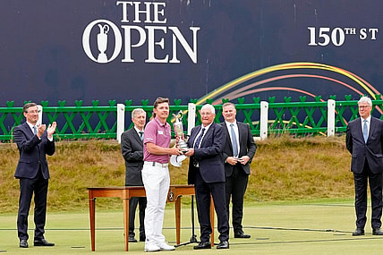 Jul 17, 2022; St. Andrews, SCT; Cameron Smith is presented the claret jug after winning the 150th Open Championship golf tournament at St. Andrews Old Course. Mandatory Credit: Michael Madrid-USA TODAY Sports