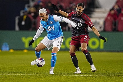 Apr 1, 2023; Toronto, Ontario, CAN; Charlotte FC forward Enzo Copetti (9) tries to control the ball against Toronto FC defender Matt Hedges (2) during the first half at BMO Field. Mandatory Credit: John E. Sokolowski-USA TODAY Sports