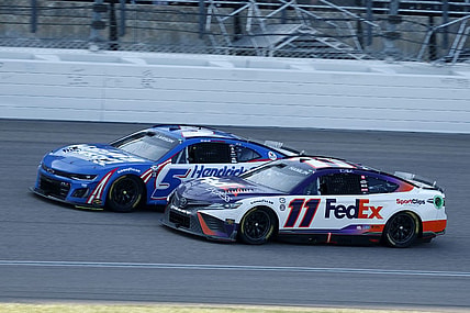 May 7, 2023; Kansas City, Kansas, USA; NASCAR Cup Series driver Denny Hamlin (11) attempts to take the lead from driver Kyle Larson (5) during the AdventHealth 400 at Kansas Speedway. Mandatory Credit: Mike Dinovo-USA TODAY Sports